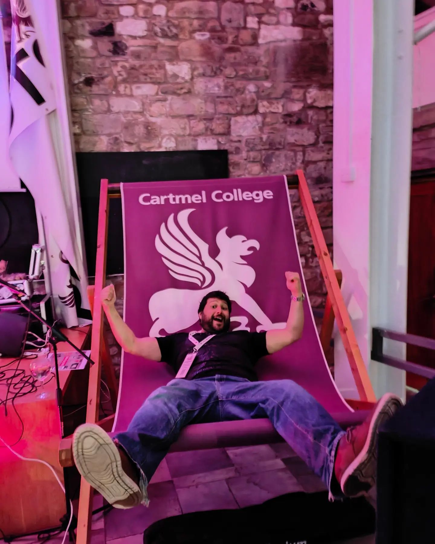 Dan Conn sitting legs akimbo on a deckchair